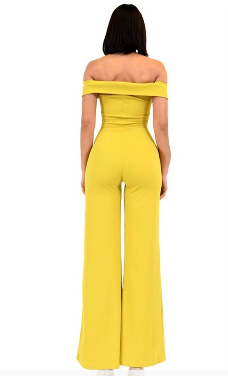 The Princess Jumpsuit is a yellow jumpsuit that has buttons on the front and is off the shoulder style